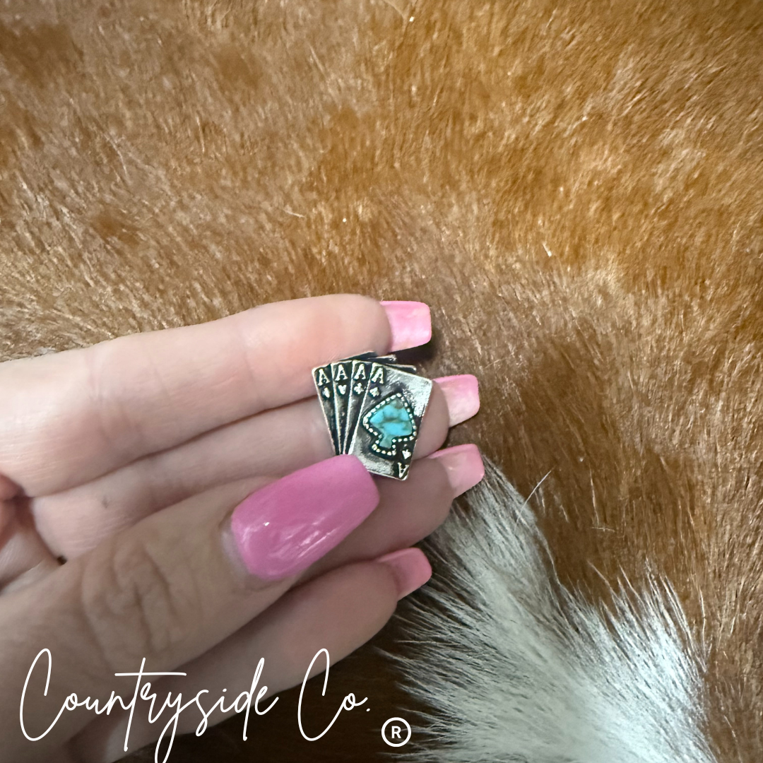 Hand holding a silver ring with turquoise stone against a fur background, featuring 'Countryside Co.' branding.
