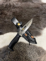 Knife with leather sheath on a fur background