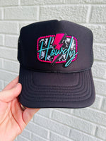 A black trucker hat with a colorful 'Howdy' text and lightning bolt embroidery patch on the front.