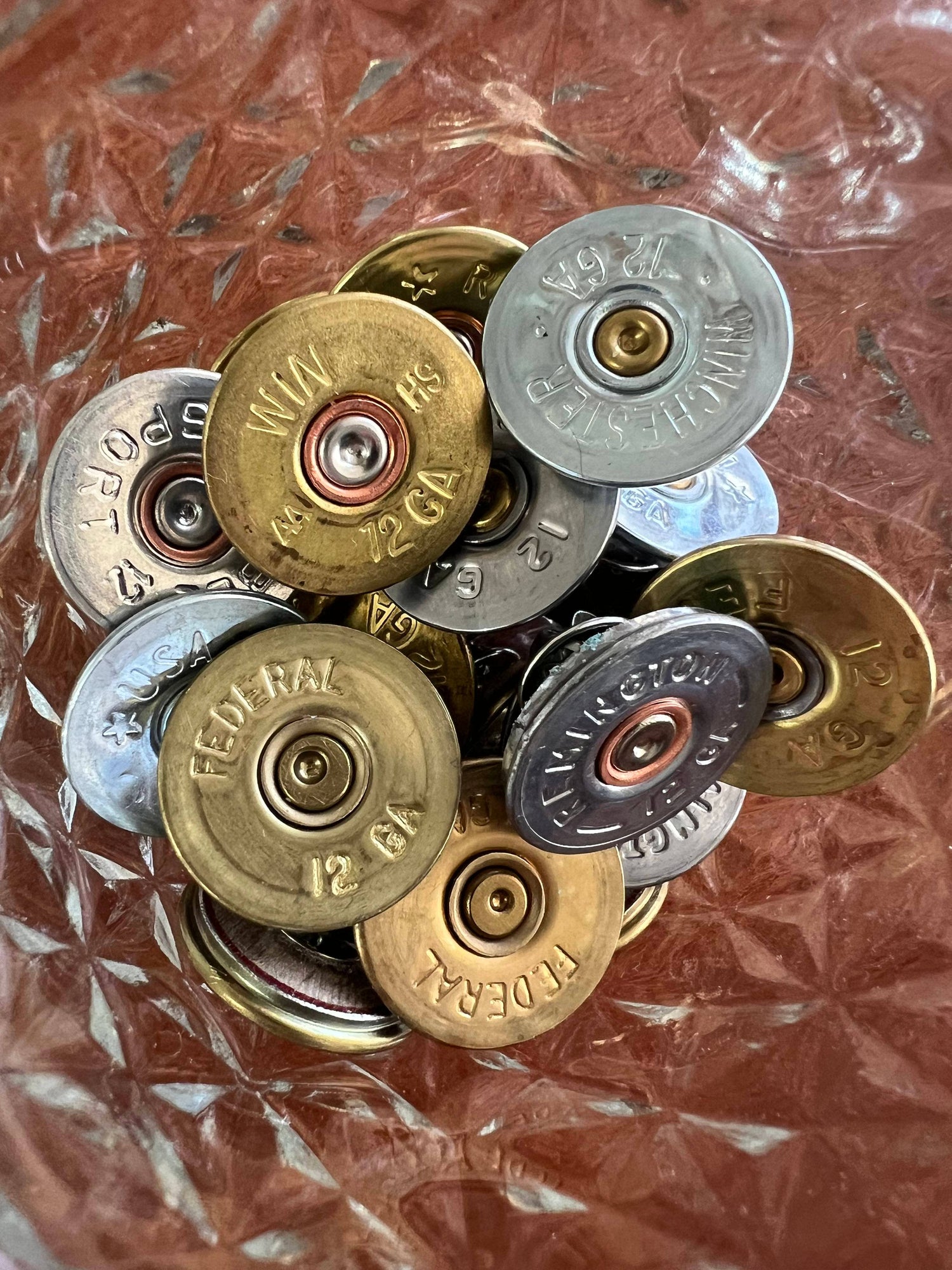 Collection of shotgun shell casings on a textured surface