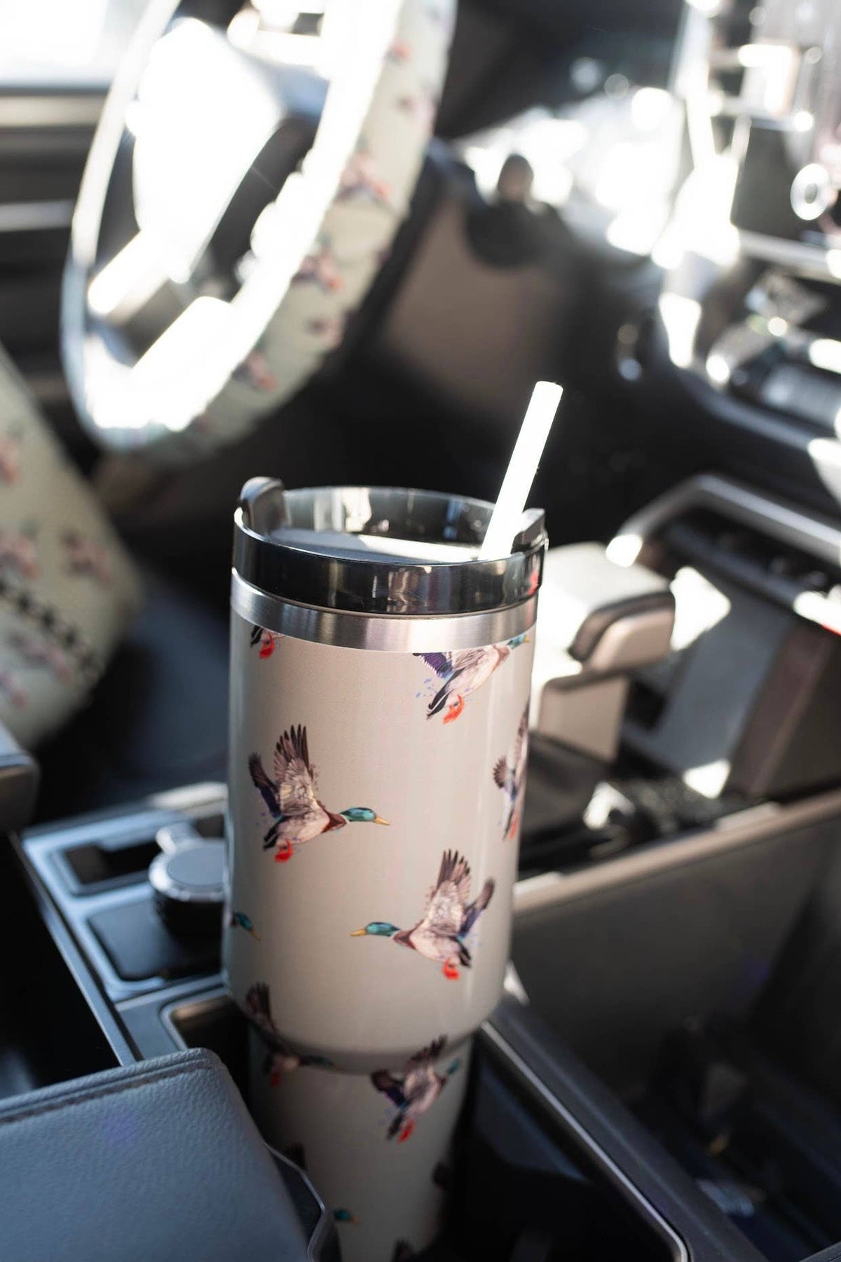 Tumbler with bird design in a car cup holder