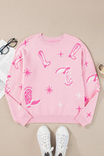 Pink sweatshirt with graphic designs on a beige surface with white sneakers and glasses.