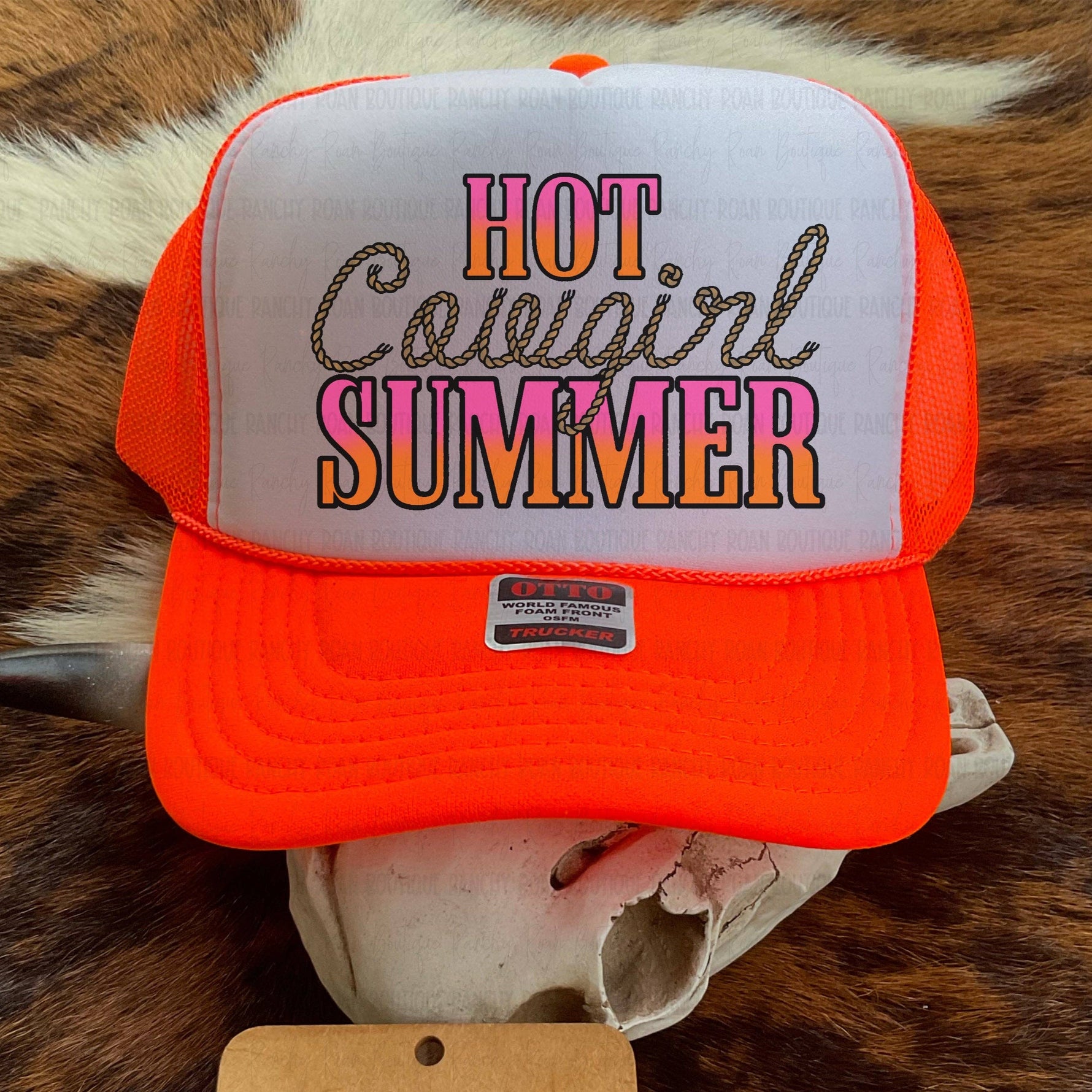 Orange and white cap with 'Hot Cowgirl Summer' text on a cowhide background