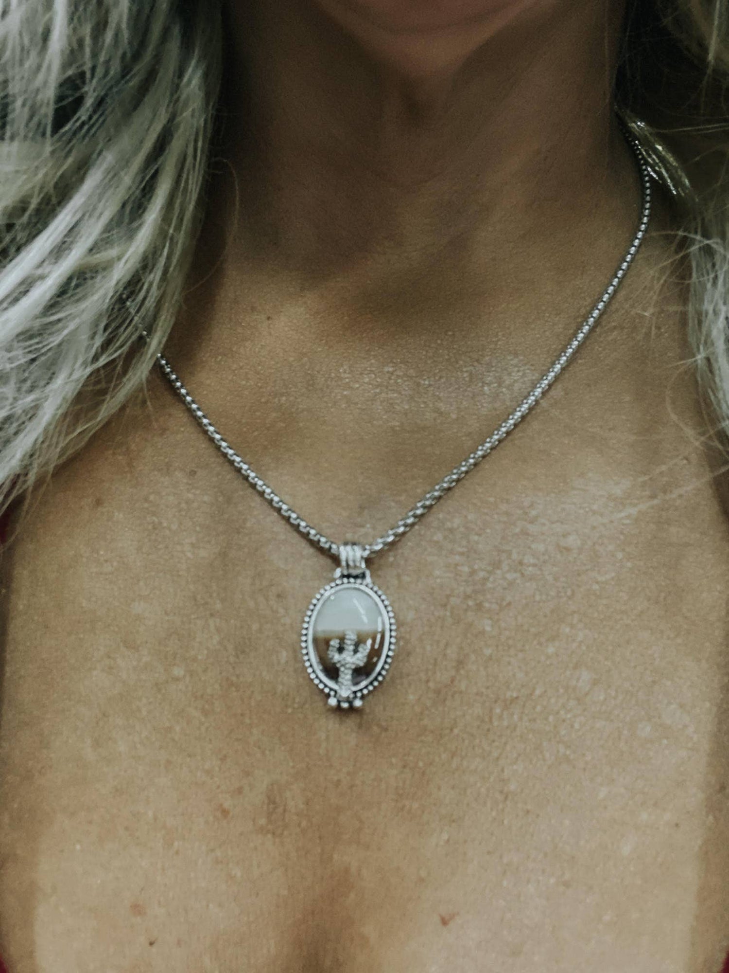 Close-up of a necklace with a pendant on a person's neck