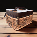 Decorative leather box with intricate patterns on a wooden surface