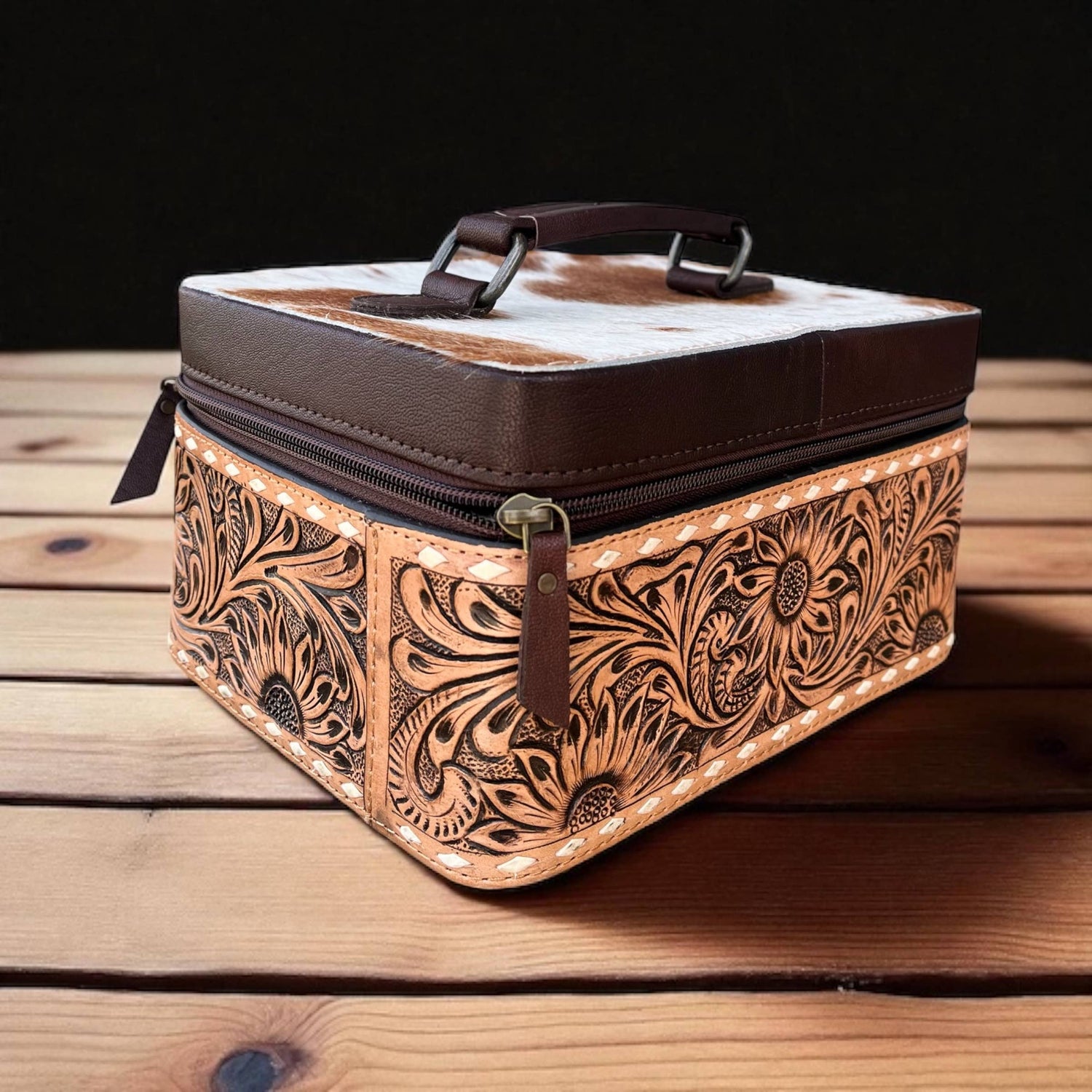 Decorative leather box with intricate patterns on a wooden surface