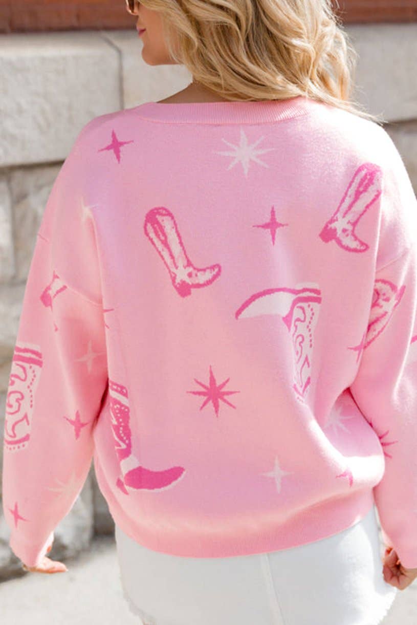 Person wearing a pink sweater with graphic designs outdoors