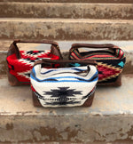 Three small bags with patterned fabric tops on a rustic wooden surface