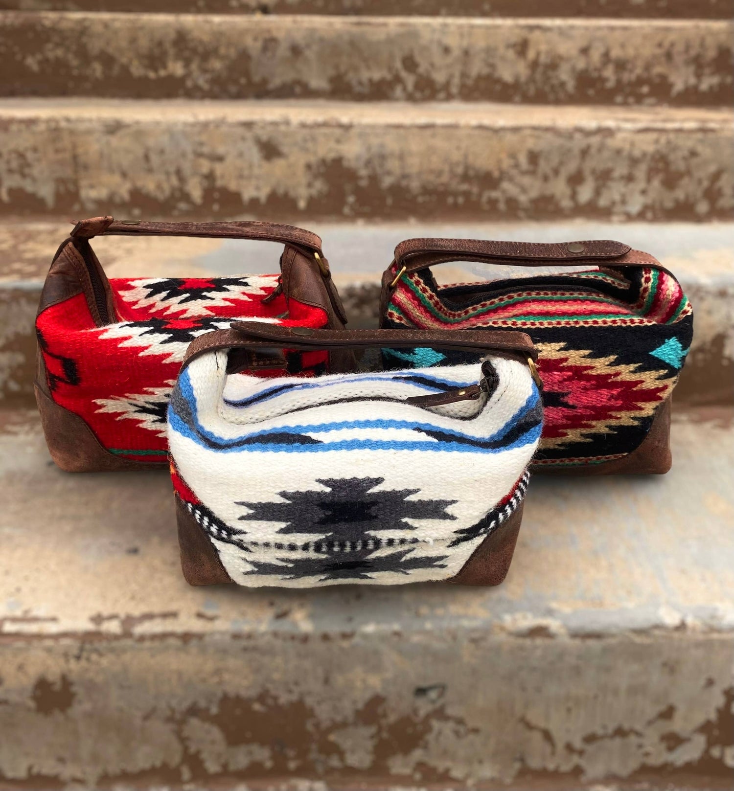 Three small bags with patterned fabric tops on a rustic wooden surface