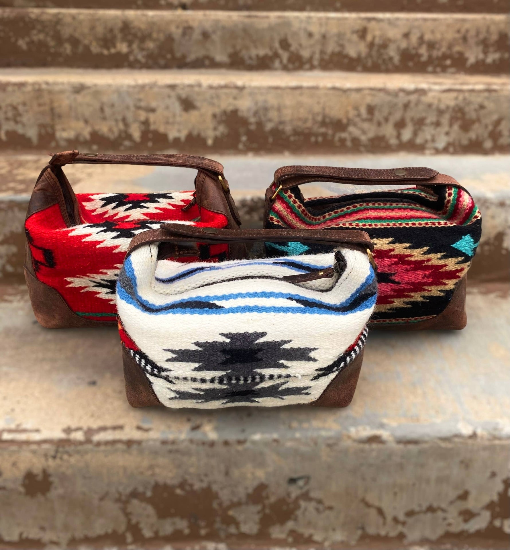 Three small bags with patterned fabric tops on a rustic wooden surface