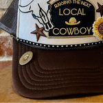 Brown bag with a decorative patch featuring text and graphics on a wooden surface